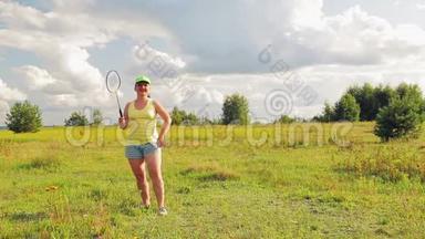 一个在空地上<strong>打羽毛球</strong>的女人发球和击球